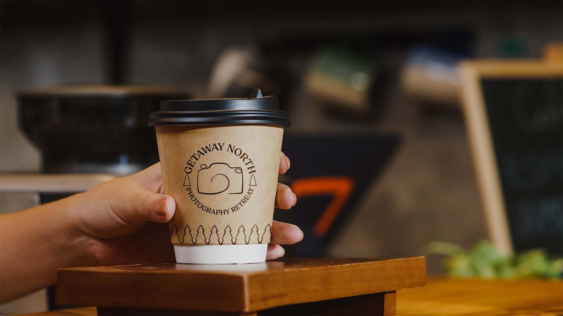 Young Asia female barista serving take away hot coffee paper cup